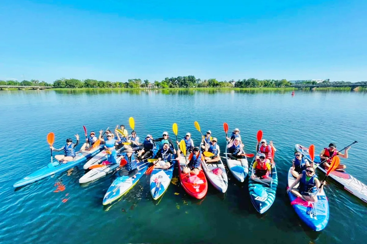 Group paddleboarding and kayaking on the Perfume River in Hue, Vietnam